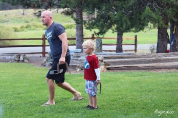 Britton teaching Bodie how to play horse shoes.