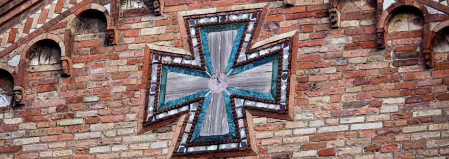 A close up of a cross on the facade of the Basilica of Santo Stefano in Bologna, Italy March 2024.